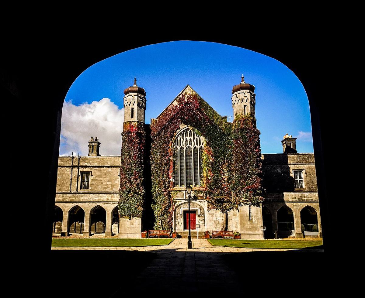 Looking through a dark arch towards the Quadrangle courtyard in September 2018