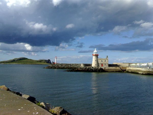 The lighthouse and water at Howth Harbour.