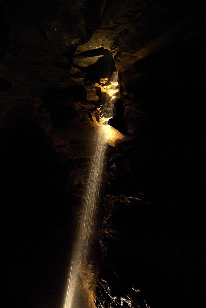 Illuminated waterfall inside Aillwee Cave