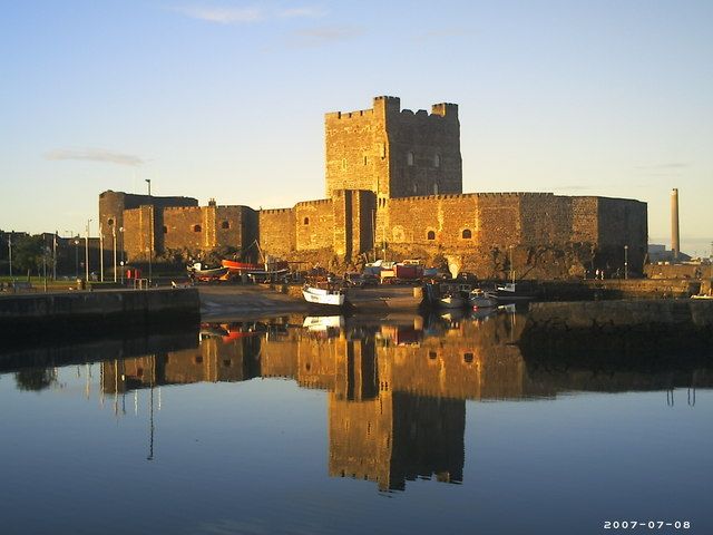 Carrickfergus Castle reflected in the harbour at sunset