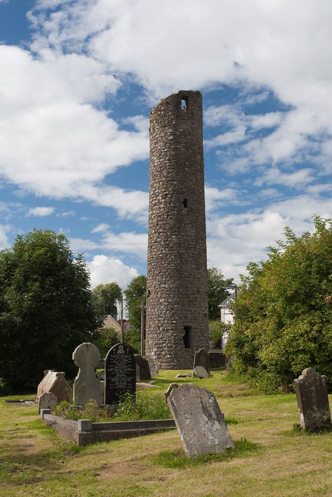 Clones Round Tower rising above the surrounding burial ground
