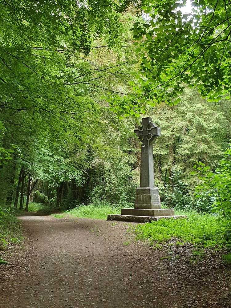 A stone cross beside a woodland path in Curraghchase Forest Park