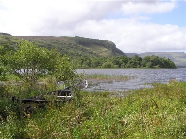 Glenade Lough with reeds, trees and surrounding hills