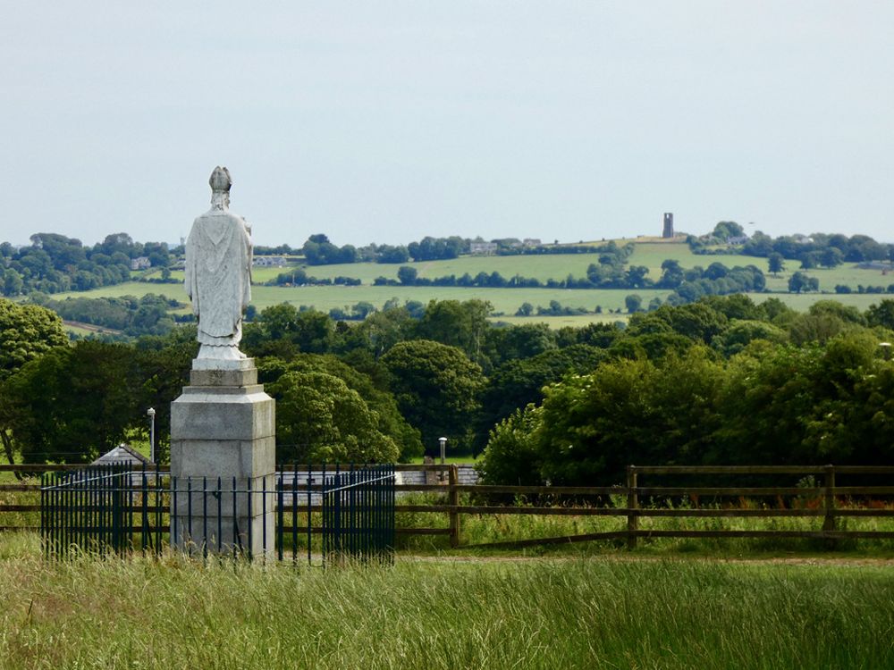 A statue and countryside view at the Hill of Tara