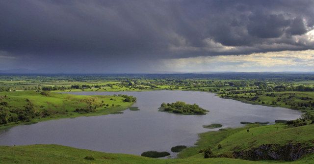 Lough Gur and its islands beneath a cloudy sky