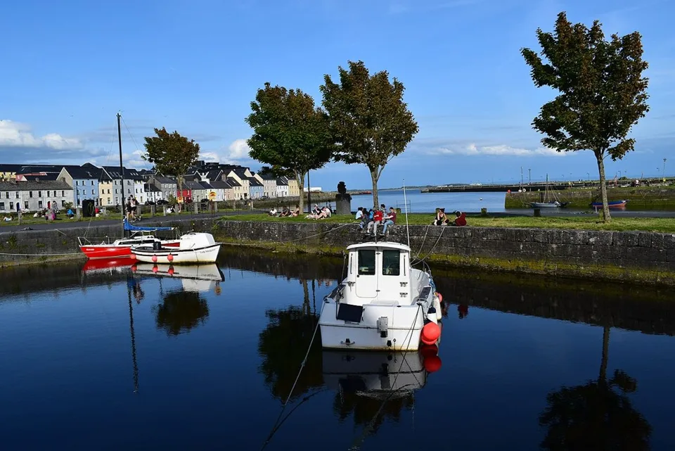 Small boats in Claddagh Basin with the Long Walk beyond in May 2020